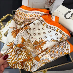 Detailed view of fashionable printed silk scarf with chic chain and leopard patterns for women.
