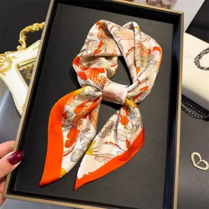 Closeup detail view of the elegant botanical print silk square scarf, featuring smooth texture.