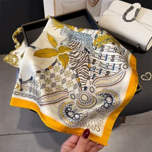Luxurious printed silk square scarf with vibrant leopard and foliage design, versatile shawl.