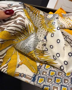 Luxurious printed silk square scarf with elegant tropical leaf and vintage geometric patterns.