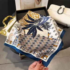 Detailed close-up of luxurious printed silk square scarf featuring elegant geometric chain motifs.