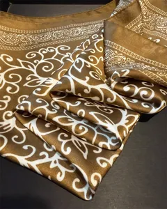 Detailed shot of retro brown silk square scarf with elegant white paisley and scroll pattern.