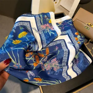 Elegant 70cm silk feel square scarf featuring chic blue botanical floral and insect print design.