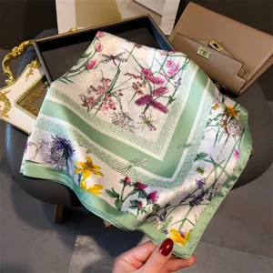 Square silk scarf with green border and floral print, elegant neckerchief for women.