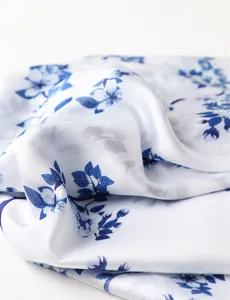 Elegant blue floral print imitation silk scarf, soft draped detail shot for women fashion.
