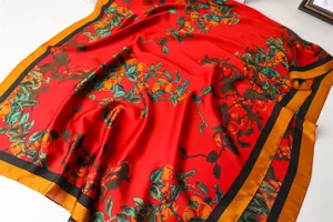 Red silk scarf with vibrant fruit print and elegant black gold border for women.