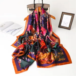 Detailed view of luxury artistic floral print long silk scarf, vibrant multicolor shawl.