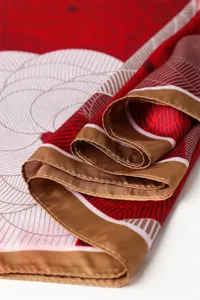 Exquisite printed silk scarf with elegant brown border and geometric floral design.