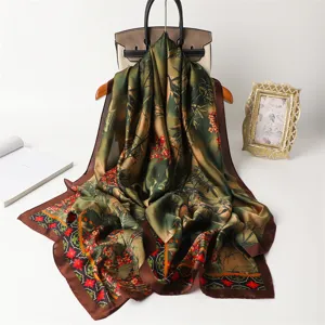 Detailed view of the elegant green floral silk scarf with bamboo print and brown border.