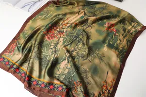 Green silk scarf detail featuring traditional bamboo and plum print with elegant brown border.