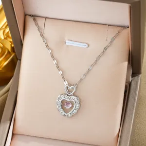 Detailed view of a stunning double heart pendant necklace with shimmering stones and pink center.