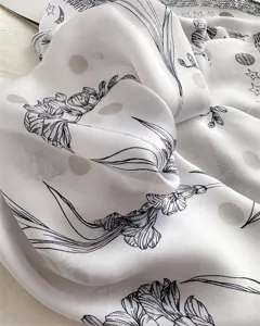 Close-up detail of a 70cm imitation silk square scarf with elegant floral and star print.