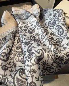 Detailed view of a 70cm paisley print imitation silk square scarf, elegant neckerchief for spring.