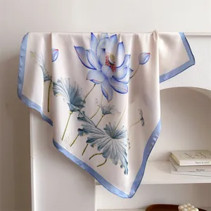 Detail shot of a 70cm silk-like floral square scarf featuring elegant blue lotus print and blue border.