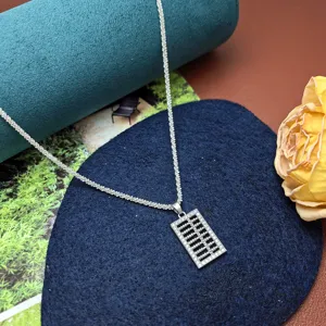 Close-up shot of the sparkling rhinestone abacus pendant necklace equipped with a delicate chain.