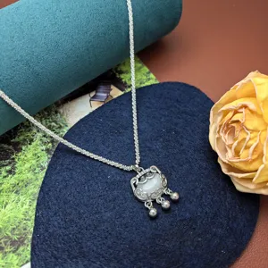 Exquisite silver lock pendant necklace detail, sparkling chain with traditional style charm.