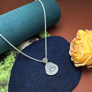 Detailed close-up of a sparkling silver chain necklace with a dazzling rhinestone pendant.