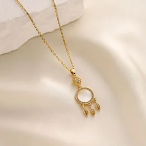 Gold cat's eye dreamcatcher pendant necklace close-up detail shot elegant fashion jewelry