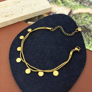 Detail shot of gold double layer necklace with small round disc pendants and extension chain.