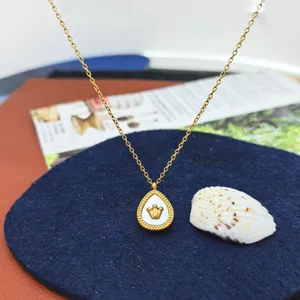 Gold crown teardrop shell pendant necklace detailed view, elegant fashion jewelry accessory.