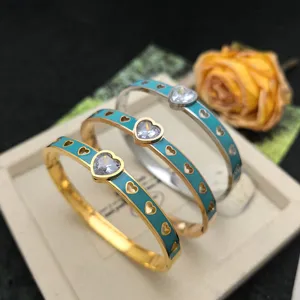 Chic titanium steel bangle bracelet featuring blue enamel inlay and sparkling heart crystal design.