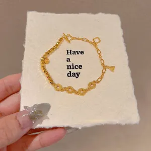 Exquisite gold-plated beaded bracelet with coin charms and toggle clasp for women.