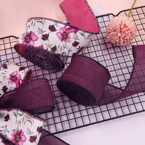 Detailed view of purple floral printed and solid wired burlap ribbon, perfect for gift wrapping.