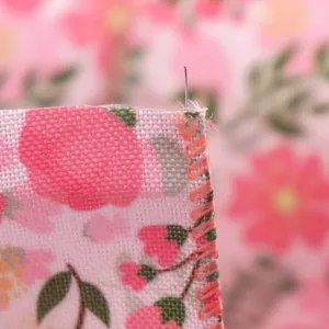 Close-up detail of rose red floral wire-edge imitation linen ribbon showcasing textured edge.