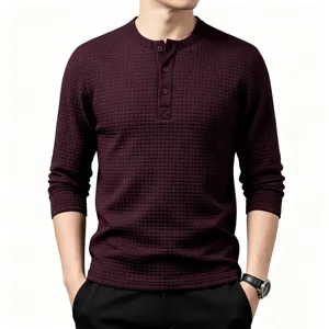 Detailed view of men waffle knit long sleeve henley shirt with textured grid pattern in burgundy.