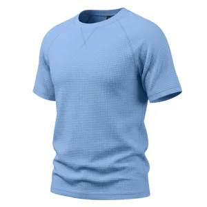 Detailed view of light blue waffle knit short sleeve t-shirt, raglan crewneck casual top.