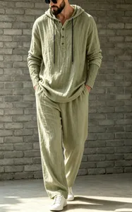 Detail view of men's casual hooded henley shirt and trousers set in sage green linen.