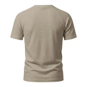 Back view detail of men khaki waffle knit short sleeve t shirt showing raglan seam texture.