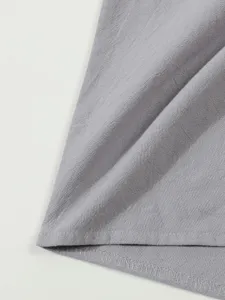 Men's grey linen long-sleeve shirt fabric detail, breathable casual beach wear texture.