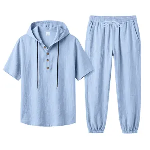 Detail view of light blue men's hooded linen short sleeve shirt and casual long pants set.