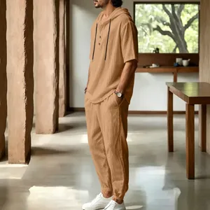 Close detail view of men casual breathable linen hooded short sleeve top and pants set.