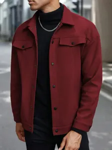 Detail view of men's burgundy wool jacket, classic lapel, snap button closure, casual style.