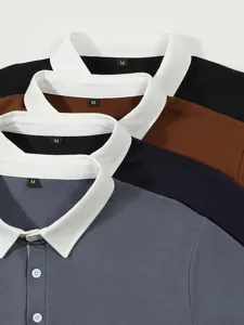 Close-up detail of contrast white collar long sleeve polo shirt stack showing multiple colors.