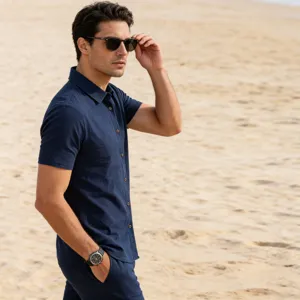 Detail showcase of men's casual short sleeve linen shirt in deep blue, beach scene.
