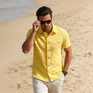 Detailed view of men's yellow linen short sleeve casual beach shirt showing fine fabric texture.