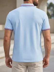 Back view detail of light blue men short sleeve polo shirt with striped collar and cuffs.
