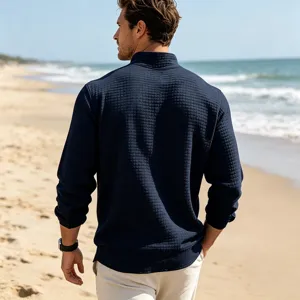 Detail view of men's dark blue waffle knit stand collar casual sweatshirt on beach scene.