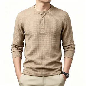 Men's waffle knit long sleeve henley shirt close up showcasing textured fabric and button placket.