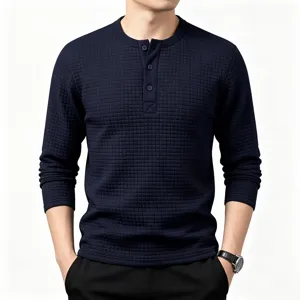 Detailed view of men's dark blue waffle knit long sleeve Henley shirt with button placket.