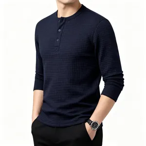 Close-up detail of men's waffle knit long sleeve Henley shirt in dark blue with button placket.