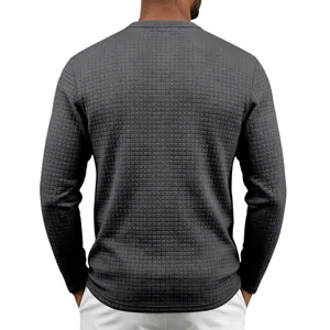 Dark gray waffle knit texture detail of men's casual long sleeve shirt, cozy everyday wear.