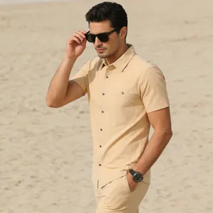 Detailed view of men's casual linen short sleeve shirt and shorts set on beach model scene.