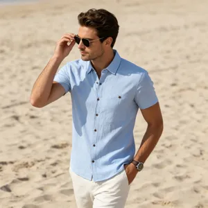 Men's casual short-sleeve shirt detail view, light blue linen fabric texture, beach scene.