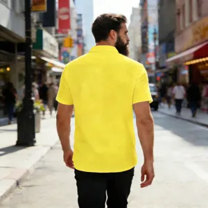 Back view of a casual yellow linen short sleeve shirt on a model, outdoor street detail shot.