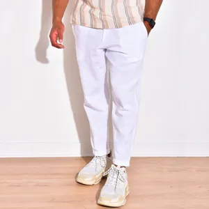 Detail view of men's white linen casual pants featuring breathable fabric and relaxed fit for summer.