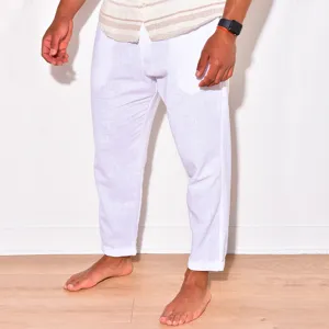 Detail view of men's white linen casual pants worn by a model, breathable fabric.